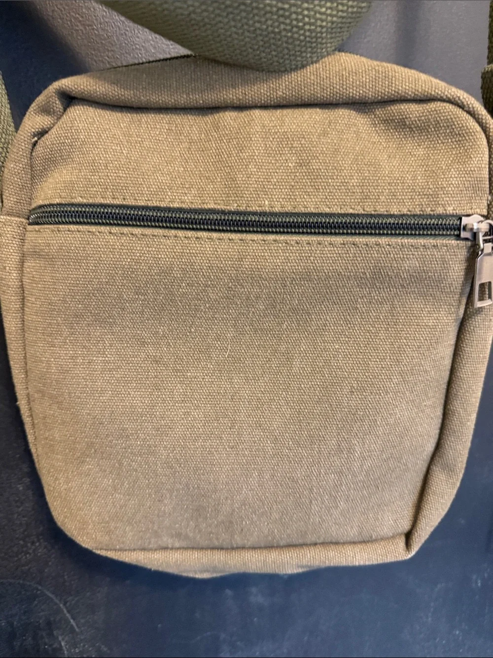 Unisex crossbody Nupouch crossbody bag. Olive colored with tan accent patch.